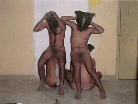 Hooded and naked Iraqi prisoners are seen inside the Abu Ghraib prison near Baghdad in this undated photo released on April 30, 2004.