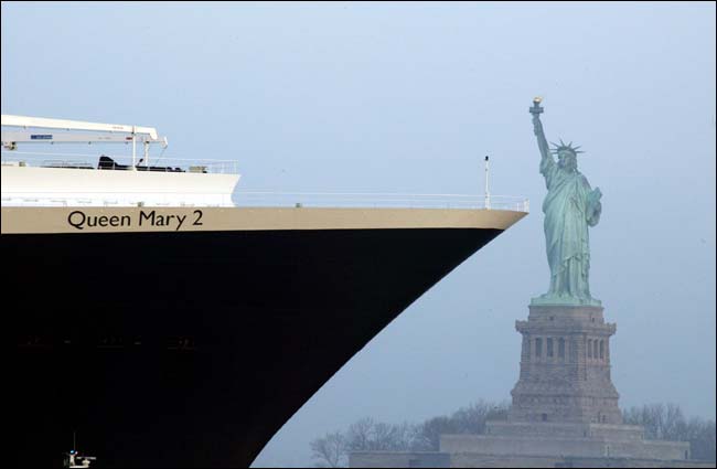 The Queen Mary 2 past the Statue of Liberty, New York, April 22, 2004.