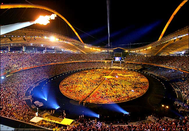 The Olympic torch glowing over the main Olympic stadium during the Athens 2004 Olympic Games opening ceremony, August 13, 2004.