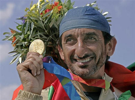 Ahmed Al-Maktoum of the United Arab Emirates displays his gold medal after winning the men's double trap finals, in Athens at the 2004 Olympic Games, August 17, 2004.