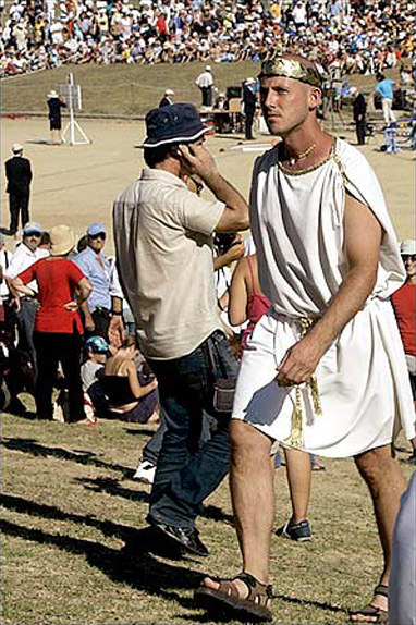 Shot-put spectator Ted Karkazis from Chicago got into the spirit of the event by wearing a traditional Greek toga during the shot-put final event at the 2004 Athens Summer Olympic Games, the ancient stadium used for Olympic competition for the first time in nearly 16 centuries, Ancient Olympia, Greece, August 18, 2004.