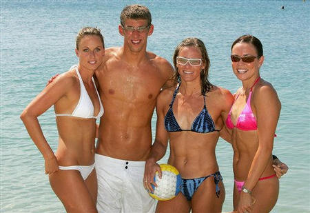 Swimmers from the United States Amanda Beard, Michael Phelps, Jenny Thompson and Natalie Coughlin gather for a group photo on a beach while participating in a Speedo sponsored event in Athens, August 24, 2004.
