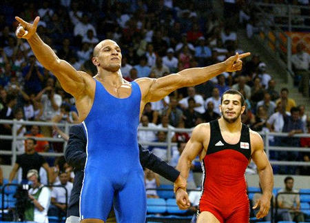 Karam Gaber Ibrahim of Egypt, celebrates after defeating Ramaz Nozadze of Georgia, during the Men's Greco-Roman 96kg wrestling final at the 2004 Olympic Games in Athens, Aug. 26, 2004