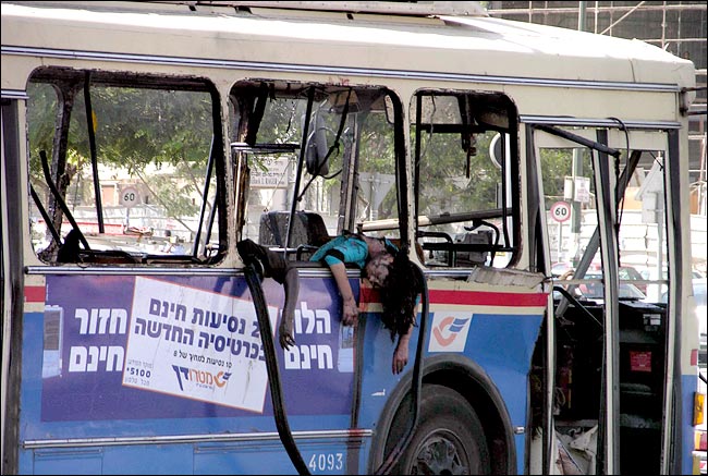 Muslim suicide bombers blow up two buses killing at least 16 people, including this child, and injuring more than 100 others, Beersheba, southern Israel, August 31, 2004.