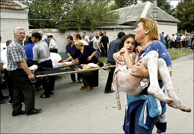 As the fighting erupted, dozens of ambulances and other cars ferried wounded children and adults from the school taken hostage by Islamic militants, Beslan, North Ossetia, September 3, 2004.