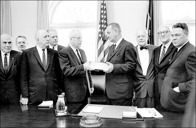 Chief Justice Earl Warren presents the report on the assassination of President John F. Kennedy to President Lyndon B. Johnson, 1964.