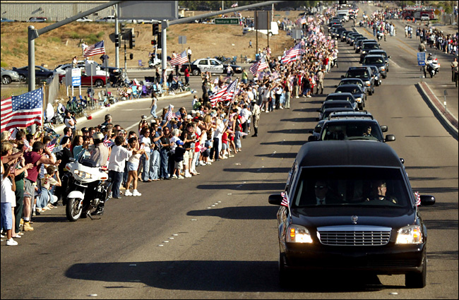 Flags waved along the motorcade route as the former president Ronald Reagan was taken to his burial service at his library on rolling California mountains Mr. Reagan loved, June 11, 2004.