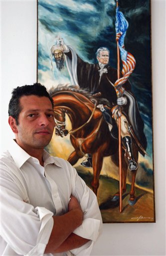 Artist Scott LoBaido stands in front of his painting called 'Have Faith,' a portrayal of President Bush on horseback, triumphantly clutching the severed head of Osama bin Laden, by the turban, at the Tribute Gallery, New York, Auguat 30, 2004.