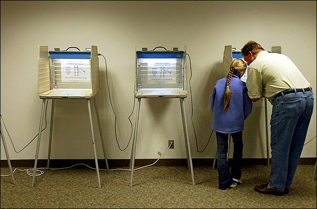 Mark Schumacher cast his vote, accompanied by his daughter, Chanhassen, Minnesota, November 2, 2004.