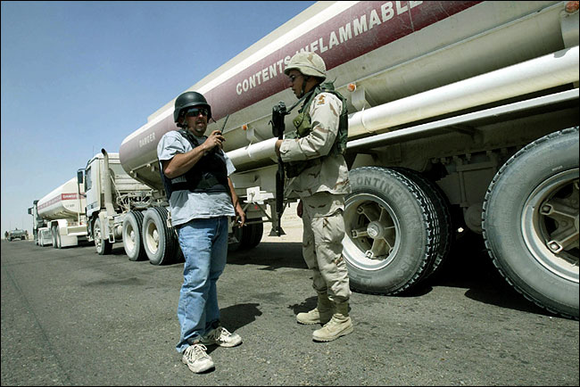 A KBR driver spoke with an American soldier during a convoy stop as it made its way through central Iraq, September 2004.