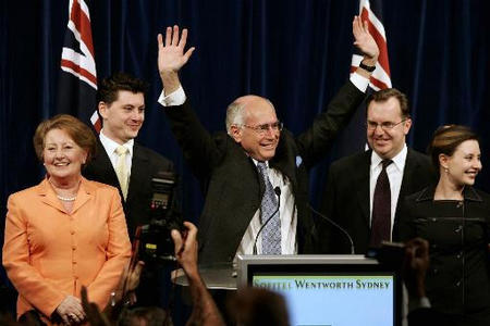 Australian Prime Minister John Howard, after scoring a convincing victory in Australia's federal election and winning a historic fourth term in a vote, waves to his party faithful to claim victory, with his son Tim and wife Janette, left, son-in-law Rowan MacDonald and daughter Melanie, right, Sydney, October 9, 2004.