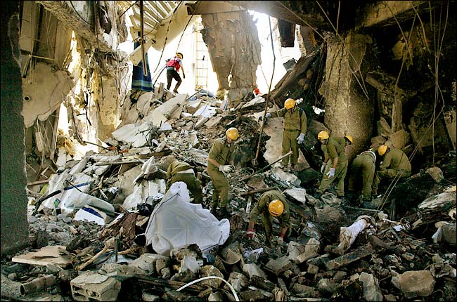 Rescue workers search for more victims in the rubble of the bombed Taba Hilton Hotel, Taba, Egypt, October 8, 2004.
