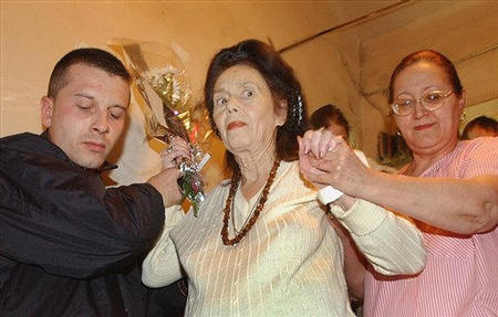 Adriana Iliescu, the 67-year-old Romanian who gave birth to baby girl Eliza-Maria two days earlier gets help to walk following a news conference at the Giulesti Maternity Hospital, Bucharest, January 18, 2005.