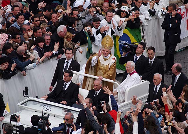 After his installation mass, Pope Benedict XVI tours St. Peter's Square in the back of a white popemobile with no protective glass, Vatican, Rome, April 24, 2005.