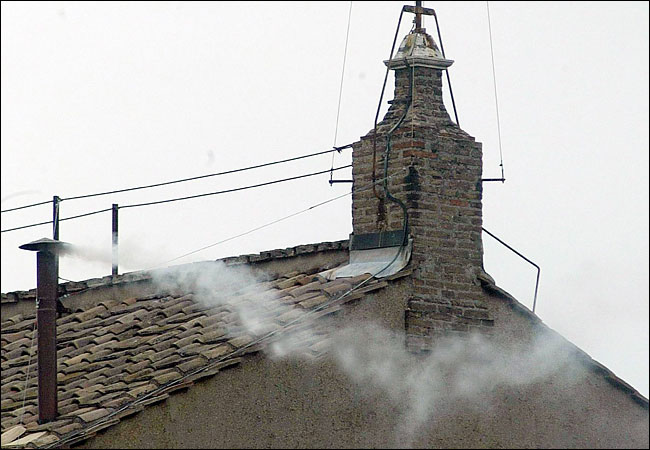 First wisp of white smoke that indicates a new pope has been elected curls up from the chimney on the Sistine Chapel, Vatican, Rome, April 19, 2005.