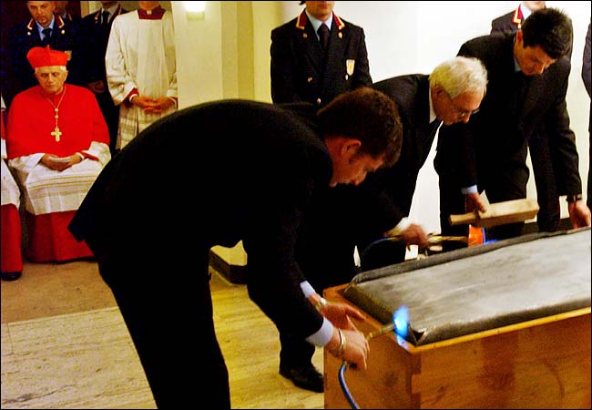 The internal zinc container of the coffin of Pope John Paul II is sealed before the public funeral Mass at the Vatican, April 8, 2005.