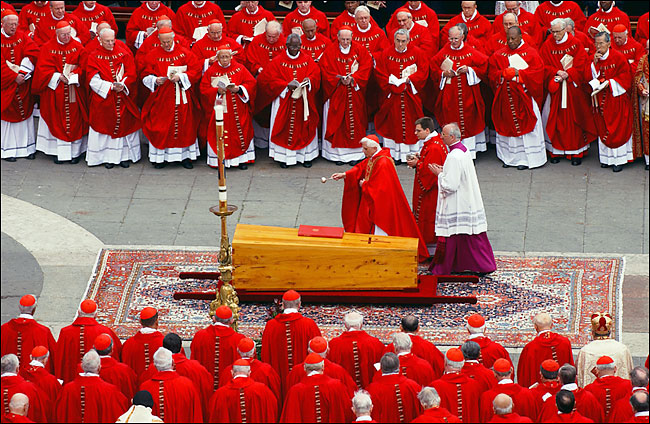 Cardinal Josef Ratzinger of Germany, who later delivered the homily, sprinkles holy water on the coffin of of Pope John Paul II during the funeral mass in front of St. Peter's Basilica at the Vatican, April 8, 2005.