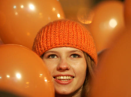 A supporter of Ukrainian opposition leader Viktor Yushchenko smiles as she takes part in a celebration rally in central Kiev, December 28, 2004. 
