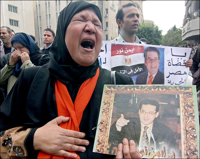 Supporters of Ayman Nour cry in despair outside a court in Cairo after he was sentenced to five years in prison for forgery, December 24, 2005.