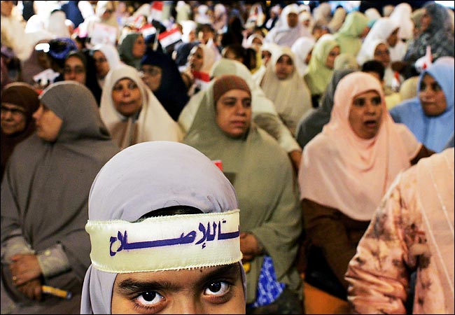 An Egyptian girl wears a headband with the Muslim Brotherhood campaign slogans, Zagazig, December 7, 2005.