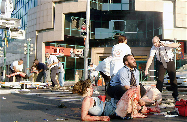 Israeli medics care for the wounded, many of them teenagers, after a suicide bomber blew himself up outside a mall in Netanya, July 12, 2005.