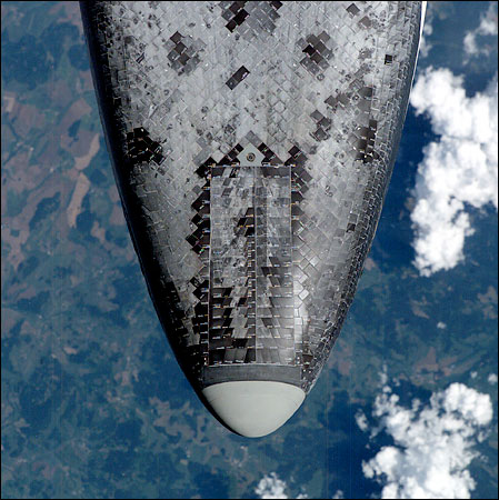 An unprecedented back-flip allowed a rare look at the Space Shuttle Discovery's heat shield, July 27, 2005.