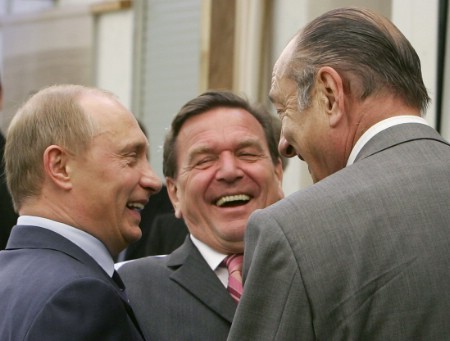 Russian President Vladimir Putin (L), German Chancellor Gerhard Schroeder (C) and French President Jacques Chirac laugh as they pose for a picture in Svetlogorsk, some 40 km from Kaliningrad, July 3, 2005.