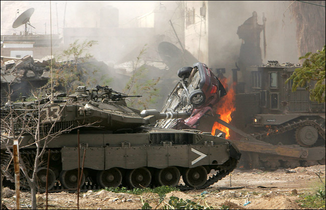 Using tanks and bulldozers, Israeli military storm a Palestinian prison with the intent of seizing six Palestinian inmates who have been held under an unusual arrangement that also involved the U.S. and Britain, Jericho, March 14, 2006.