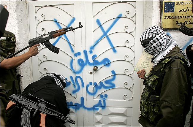 Gunmen in Gaza seize the European Union office and mark it 'Closed until an apology is sent to Muslims,' as a protest of Cartoons of Muhammad that originated in Denmark and offended many Muslims, February 2, 2006.