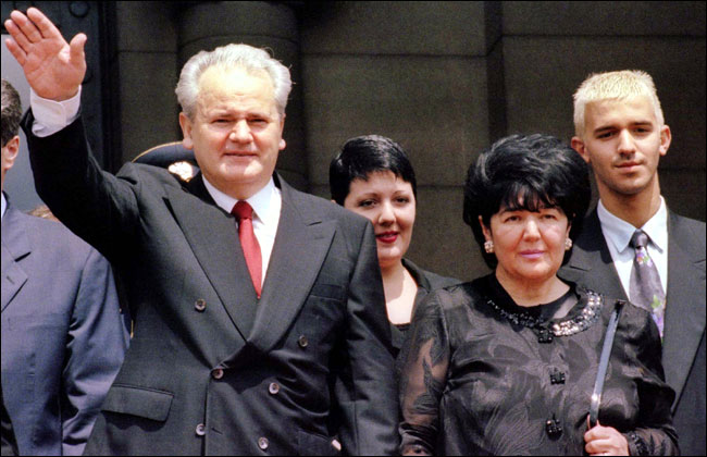 Slobodan Milosevic, flanked by his family, waves to supporters following his inauguration as Yugoslavia's president, 1997.