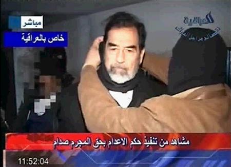 A frame grab from Iraqi state television, Al Iraqiya, shows a piece of cloth being placed around former Iraqi president Saddam Hussein's neck moments before his execution, Baghdad, early December 30, 2006