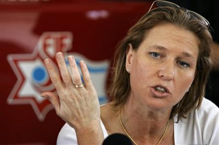 Israeli Foreign Minister Tzipi Livni speaks to firefighters as she visits the fire station in the town of Nahariyah, northern Israel, August 15, 2006.