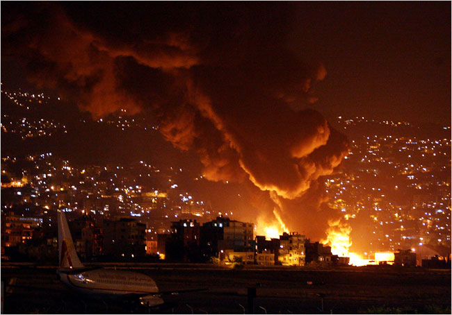Fuel tanks burn at the Beirut International Airport after it was attacked by Israeli aircraft, July 14, 2006.