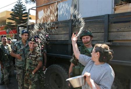 A Lebanese woman throws rice and rose petals at Lebanese soldiers after their arrival to the southern town of Marjayoun, Lebanon, Aug. 17, 2006