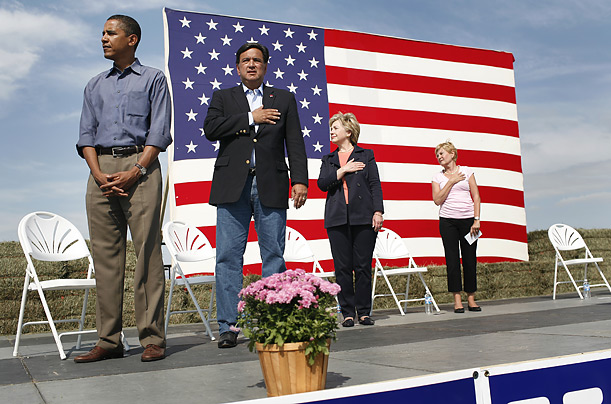 Senator Barack Hussein Obama, Governor Bill Richardson of New Mexico, Senator Hillary Clinton and Ruth Harkin stand during the national anthem that all but Senator Obama saluted, at an event in where six Democratic presidential candidates appeared, Indianola, Iowa, September 16, 2007.