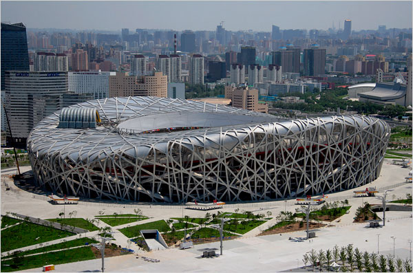 Beijing National Stadium, also known as Bird's Nest, just before it's first use for the opening ceremony of the Olympic Games, August 8, 2008.
Swiss architects Jacques Herzog and Pierre de Meuron wanted it to express a nation that is struggling to forge a new identity out of a maelstrom of inner conflict. Its elliptical latticework shell likens it to a gigantic bird's nest, bent steel columns and bulging elliptical form gives the it a surreal, moody appearance, as if it were straining to contain the forces pushing and pulling it this way and that.