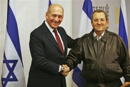 Israeli Prime Minister Ehud Olmert, left, shakes hands with Israeli Defense Minister Ehud Barak, at a press conference following a meeting of the security cabinet at the Defense Ministry, Tel Aviv, January 17, 2009.