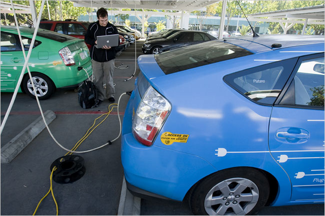 A worker tries to determine which of the companys electric rental cars, which are powered by solar panels, is his, Google Headquarters, San Francisco, October 2008.