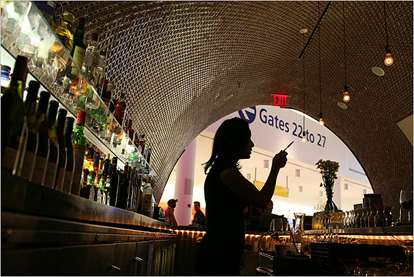 Piquillo, a tapas bar that serves fresh, plump olives and a just al dente tortilla Española, where the elaborate tiles on the arcing ceiling bend light into oily rainbows, Terminal 5 of Kennedy Airport, New York, December 2008.