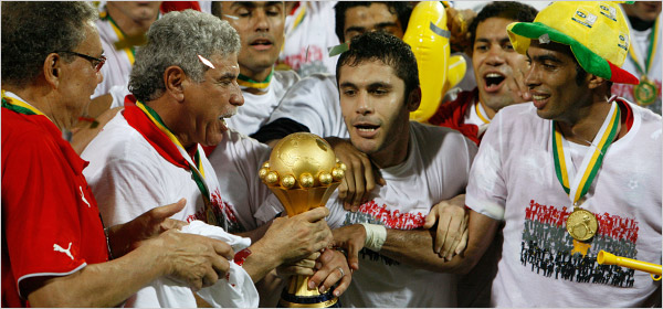 Egypt soccer coach Hasan Shehata, center left, and captain Ahmed Hasan, center right, held the cup as the team celebrated Egypt's win of its record sixth African Cup of Nations title, capturing its second championship in a row with a 1-0 victory over Cameroon in the final, Accra, Ghana, February 10, 2008.