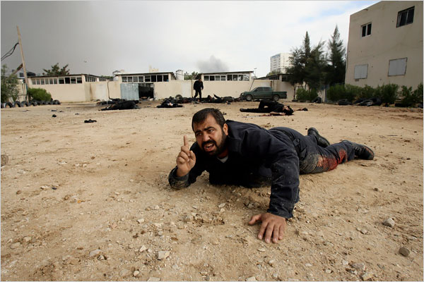 An injured man struggls at the Hamas police headquarters as hundreds of Palestinians are also killed and scores more wounded in the first hour of Israels massive attack on about 100 Hamas sites throughout Gaza in retaliation for the recent rocket fire from the area, Gaza, December 27, 2008.