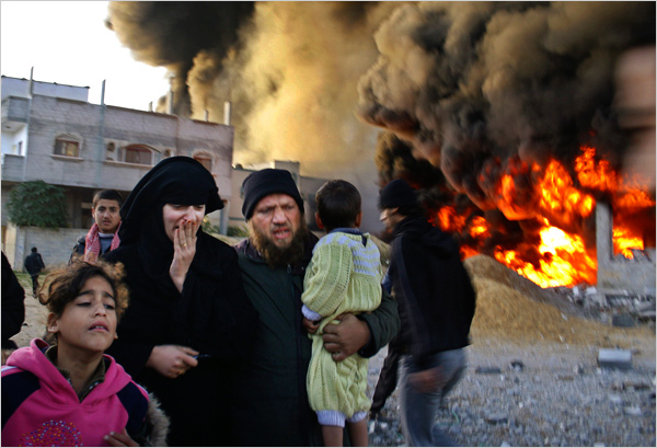On the second day of Israel’s massive attack on Hamas sites throughout Gaza in retaliation for the recent rocket fire from the area, a family flee the scene of a missile strike at Rafah, December 28, 2008.