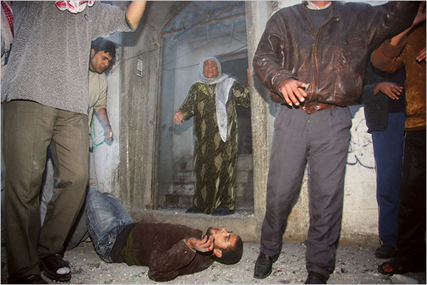 On the second day of Israel’s massive attack on Hamas sites throughout Gaza in retaliation for the recent rocket fire from the area, a wounded Palestinian man lay on the floor after an Israeli missile struck the neighboring home of a Hamas military leader in Beit Lahia, December 28, 2008.