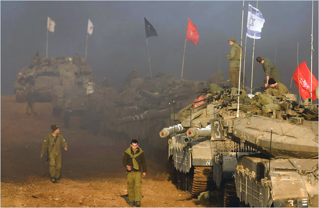 On the third day of Israels massive attack on Hamas sites throughout Gaza in retaliation for the recent rocket fire from the area, Israeli troops and tanks mass along the northern border of the Gaza Strip, December 29, 2008.
