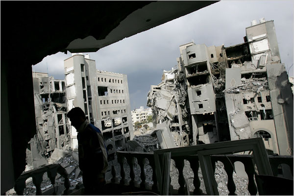 On the fourth day of Israels massive attack on Hamas sites throughout Gaza in retaliation for the recent rocket fire from the area, a Palestinian man, after an Israeli airstrike, inspects the damage to his home at the compound buildings linked to the Islamic University, the home of a top Hamas commander, Gaza City, December 30, 2008.