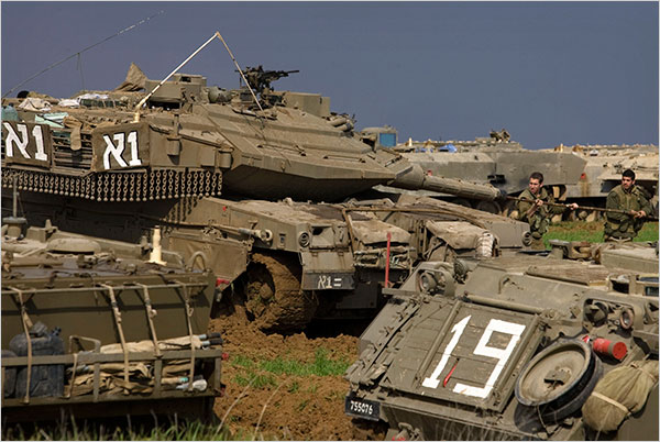 On the fourth day of Israels massive attack on Hamas sites throughout Gaza in retaliation for the recent rocket fire from the area, Israeli soldiers clean the barrel of a tank at a staging area near Israel's border with the Gaza Strip inside the two-mile war cordon created by the Israeli military along the Gaza border, December 30, 2008.