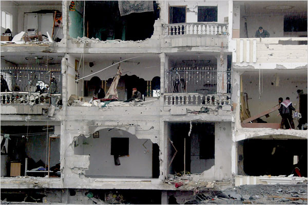 On the sixth day of Israels massive attack on Hamas sites throughout Gaza in retaliation for the recent rocket fire from the area, Palestinians inspect an apartment building in Rafah damaged in Israeli airstrikes, January 1, 2009.