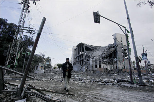 On the sixth day of Israels massive attack on Hamas sites throughout Gaza in retaliation for the recent rocket fire from the area, a man walks by the destroyed Parliament building, Gaza City, January 1, 2009.