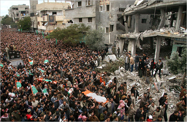 On the seventh day of Israels massive attack on Hamas sites throughout Gaza in retaliation for the recent rocket fire from the area, Palestinians conduct the funeral of Hamas leader Nizar Rayyan and members of his family who were killed the day before by an Israeli attack, Gaza Strip, January 2, 2009.