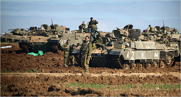 On the eighth day of Israels war against Gaza, Israeli tanks and armored personnel carriers wait at the Gaza border for a ground assault, January 3, 2009.
